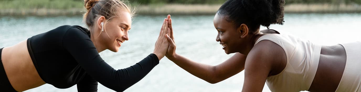Two women doing workout outdoors